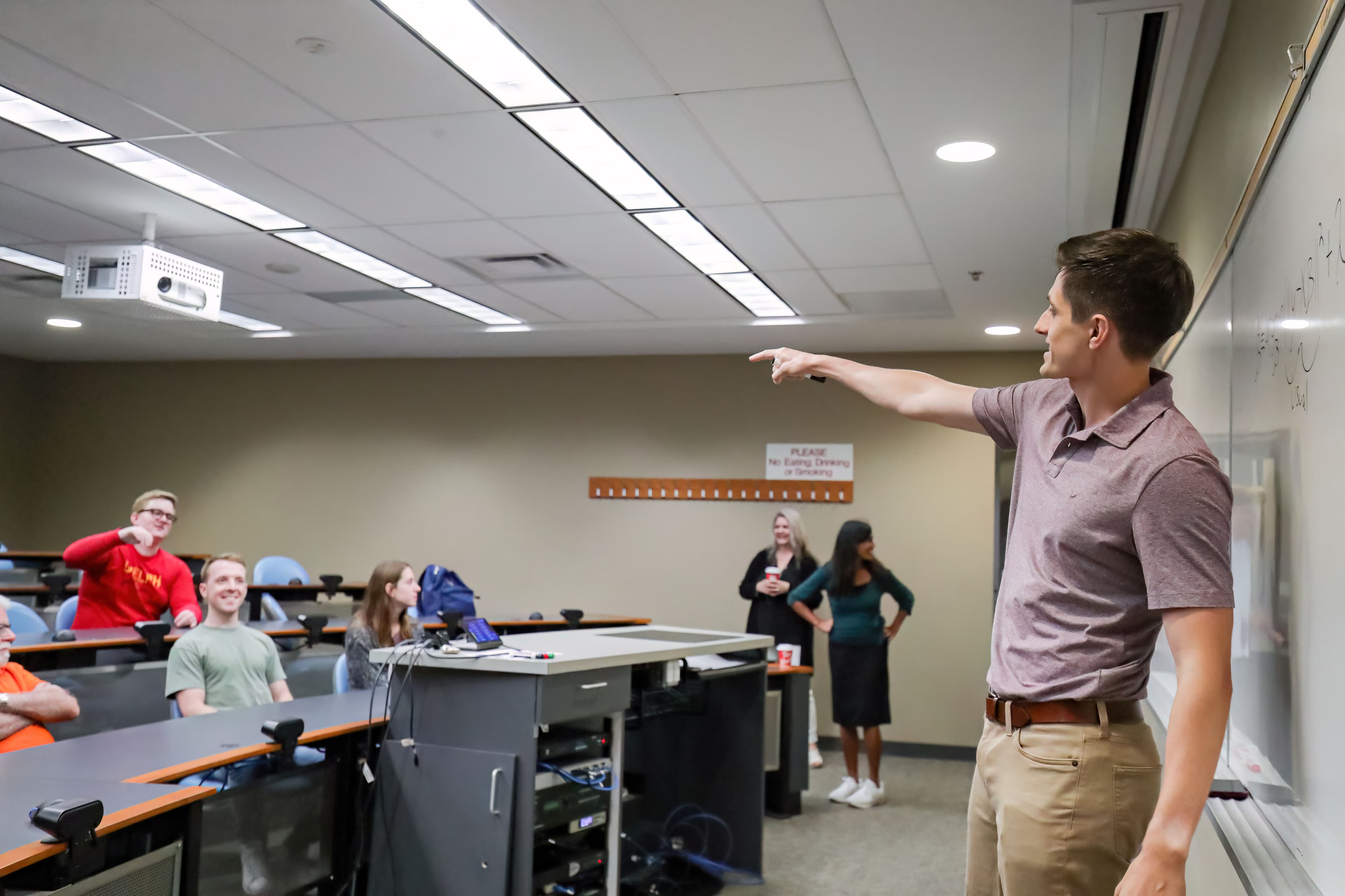 Professor pointing at students in lecture hall