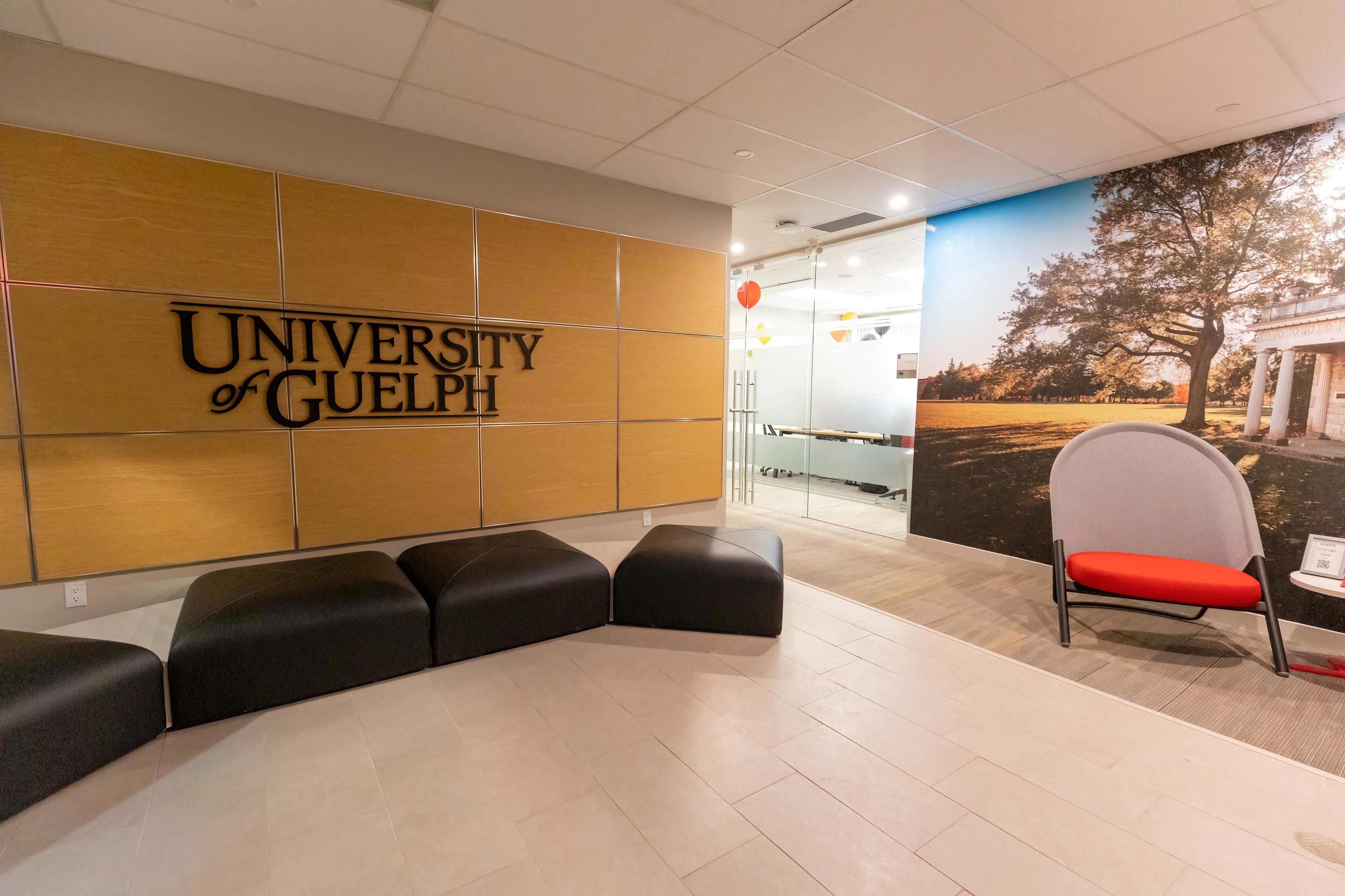 MCTI lobby with chairs, couches, and U of G sign and mural