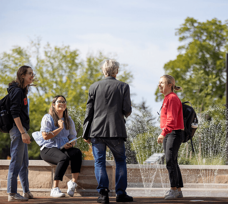 students and faculty talking