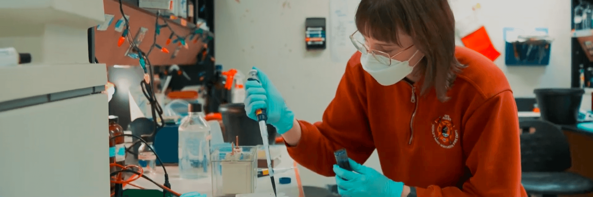a person uses a pipette in a lab